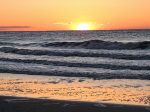 sunrise on the beach by Coman Falls